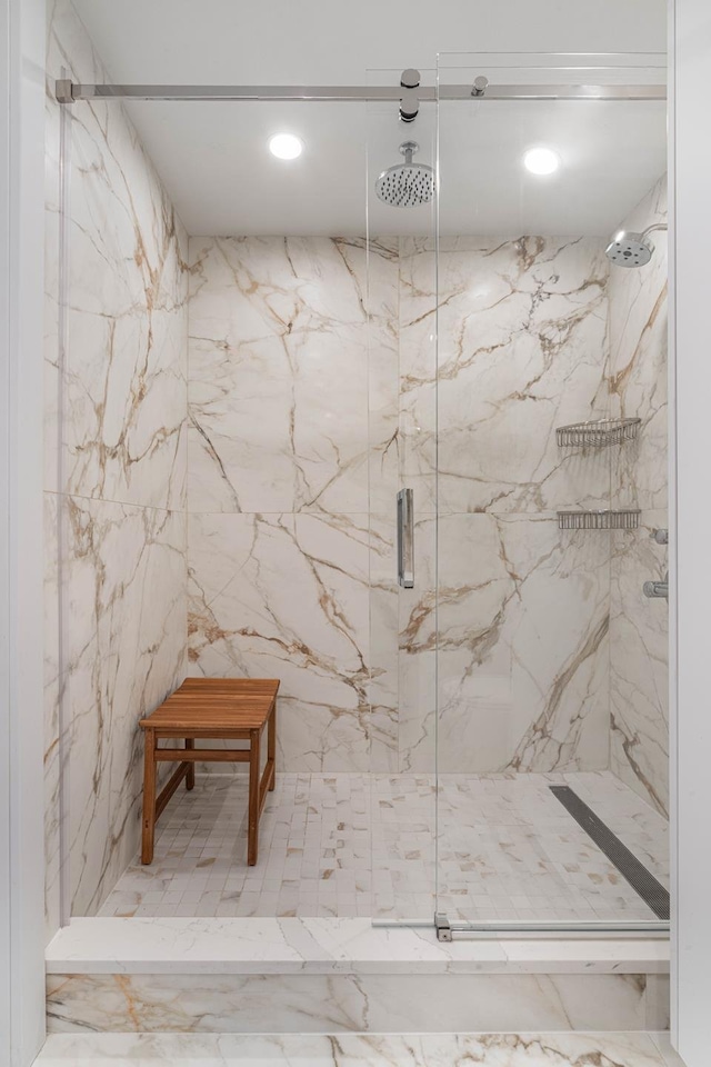 bathroom with a marble finish shower