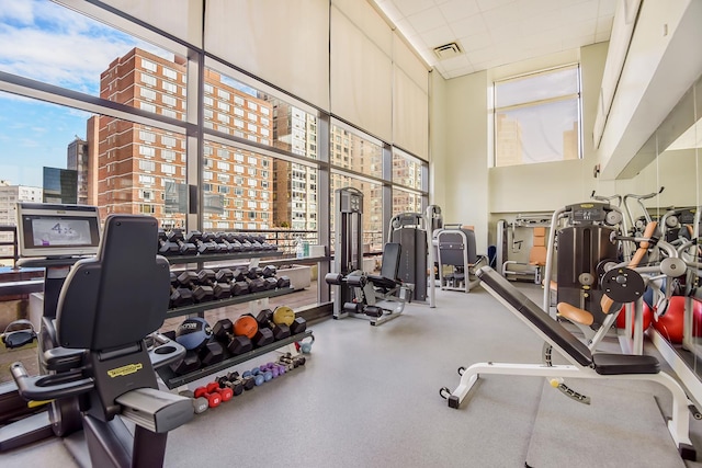 workout area with a high ceiling and visible vents