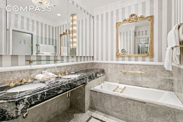 bathroom with a sink, ornamental molding, and wallpapered walls