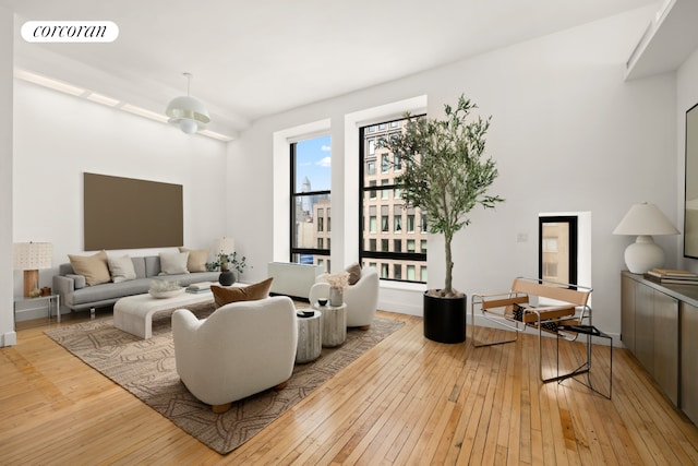 living area with light wood-style floors and visible vents