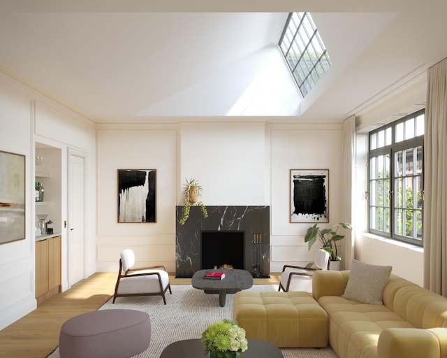 living area with a skylight, a fireplace, a decorative wall, and wood finished floors