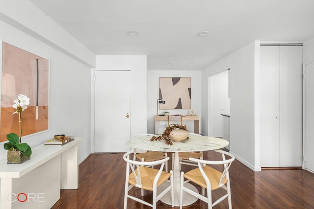 dining space with dark hardwood / wood-style flooring