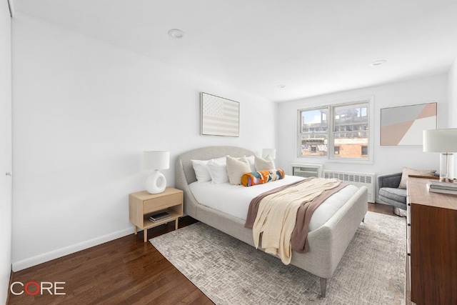 bedroom with radiator and dark hardwood / wood-style flooring