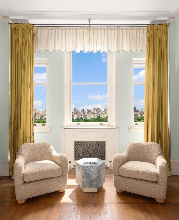 sitting room with ornamental molding, wood-type flooring, and radiator heating unit