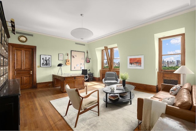 living room with crown molding and hardwood / wood-style flooring