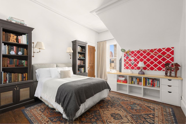 bedroom featuring crown molding and wood finished floors