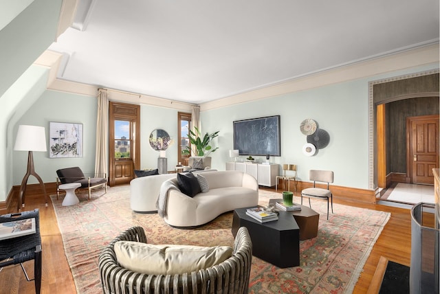 living area with baseboards and wood finished floors