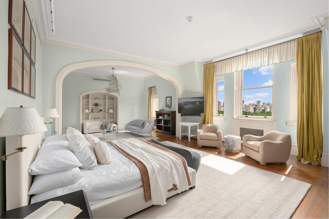 1 W 72nd St Unit 84, New York City, NY 10023 - bedroom with arched walkways, ornamental molding, and wood finished floors
