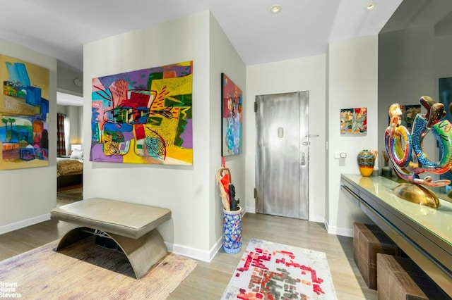 entrance foyer featuring recessed lighting, baseboards, and light wood finished floors