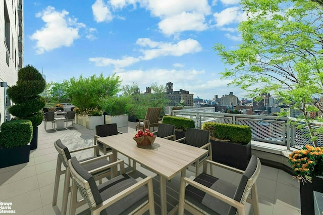 view of patio with a city view and outdoor dining space