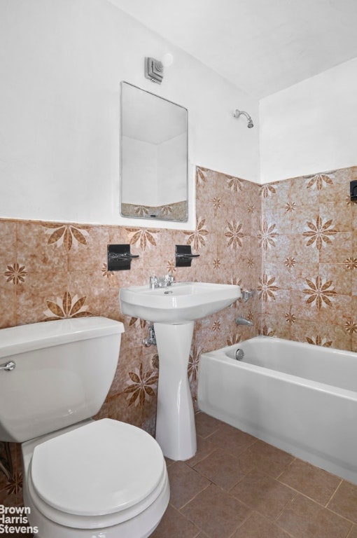 bathroom featuring tile walls, toilet, and tile patterned flooring