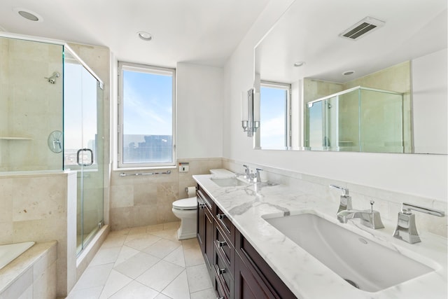 bathroom with a sink, visible vents, a healthy amount of sunlight, and tile patterned flooring