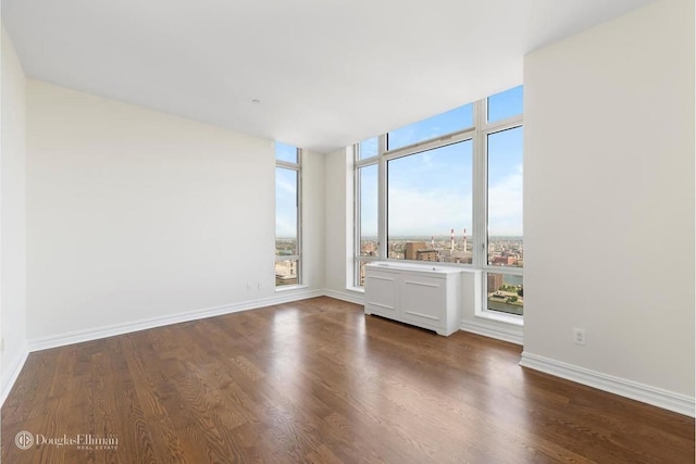 401 E 60th St Unit 38Ab, New York City, NY 10065 - unfurnished room featuring dark wood-style flooring and baseboards