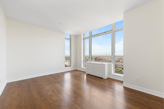 401 E 60th St Unit 38Ab, New York City, NY 10065 - spare room with dark wood-style flooring and baseboards