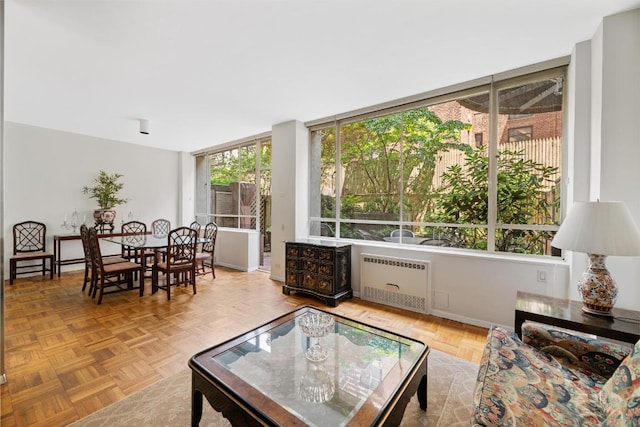 living room with light parquet flooring and radiator