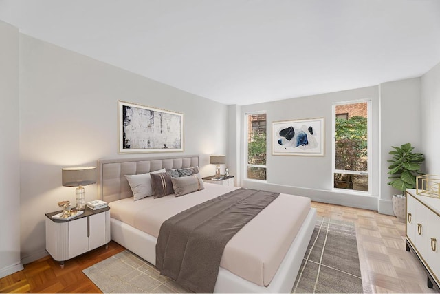 bedroom with light parquet flooring