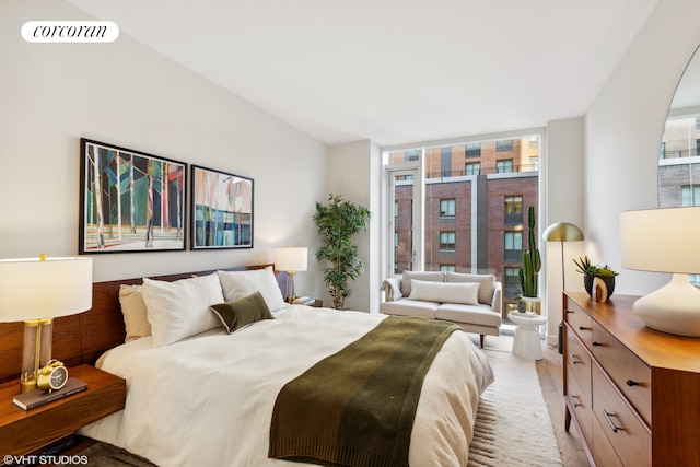 bedroom with visible vents and a wall of windows