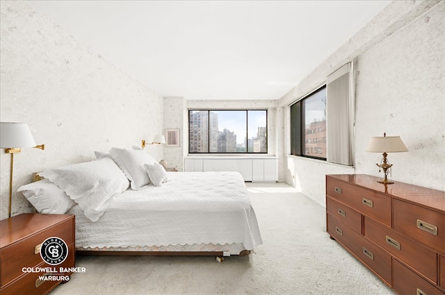 bedroom featuring a view of city and light carpet