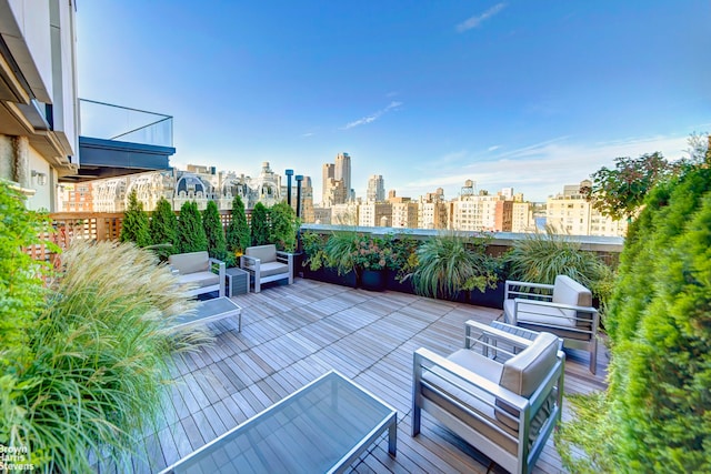 view of patio / terrace featuring an outdoor hangout area, a balcony, and a city view