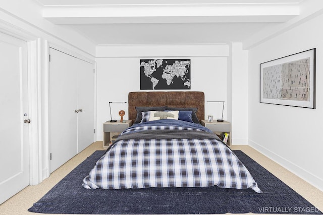 carpeted bedroom with beam ceiling