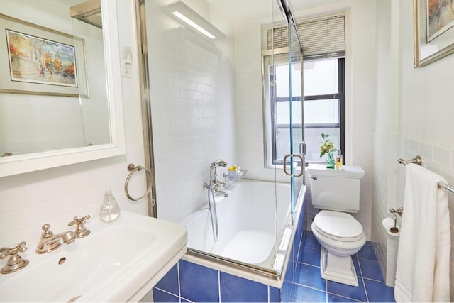 full bathroom featuring independent shower and bath, sink, tile walls, tile patterned flooring, and toilet