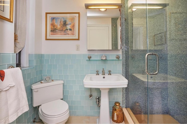 bathroom with sink, tile walls, an enclosed shower, and toilet