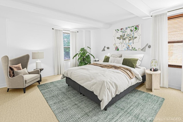 bedroom with beamed ceiling and carpet flooring