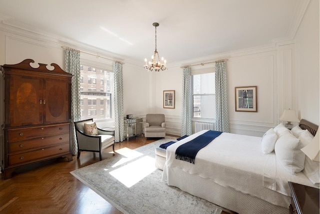 bedroom featuring parquet flooring, ornamental molding, a notable chandelier, and radiator heating unit