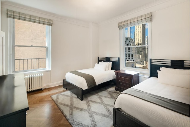 bedroom with radiator, ornamental molding, and parquet floors