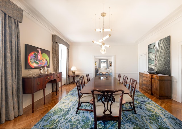 dining space featuring baseboards, an inviting chandelier, and ornamental molding