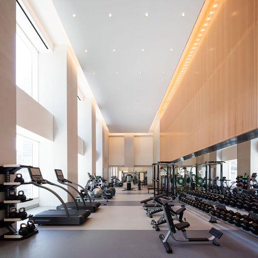 workout area featuring a towering ceiling