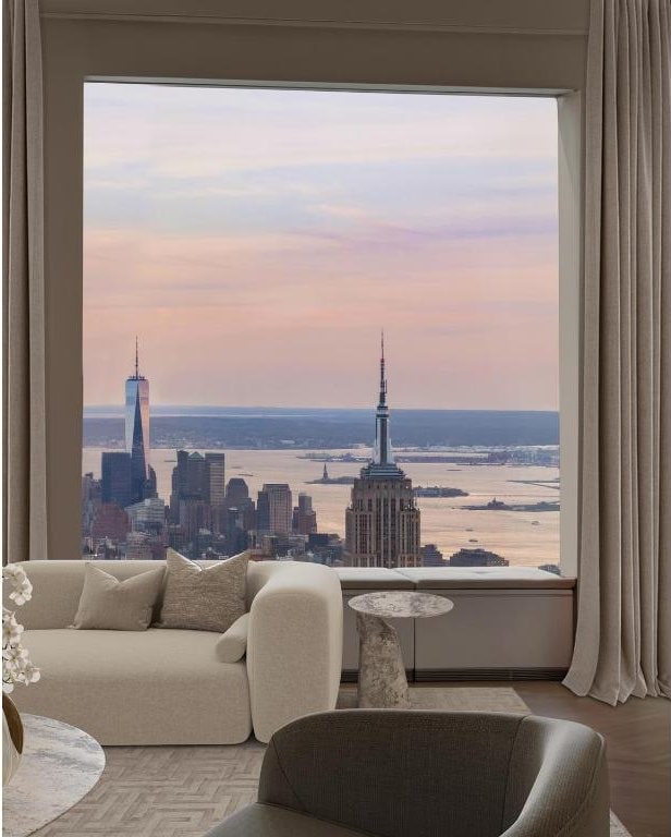 living room featuring a water view and a healthy amount of sunlight