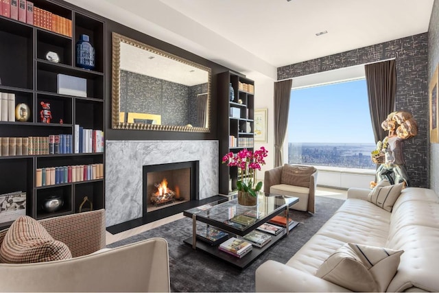 living area featuring a high end fireplace