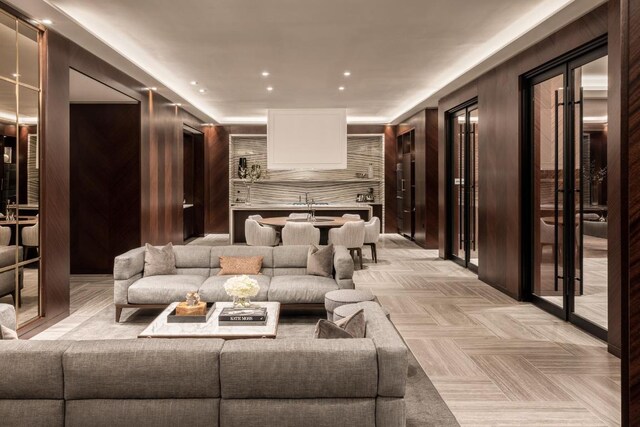 kitchen with sink, white cabinetry, tasteful backsplash, pendant lighting, and oven