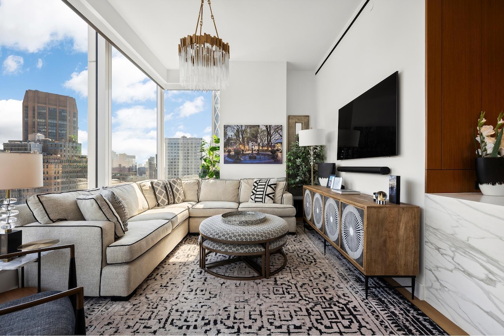 living area with a chandelier and wood finished floors