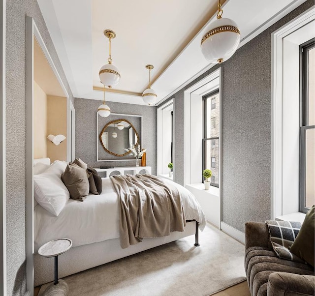 bedroom with a tray ceiling and carpet floors