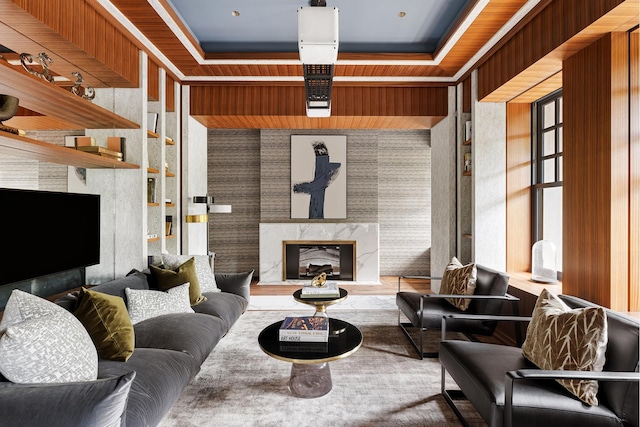 interior space featuring a fireplace, a tray ceiling, and wallpapered walls