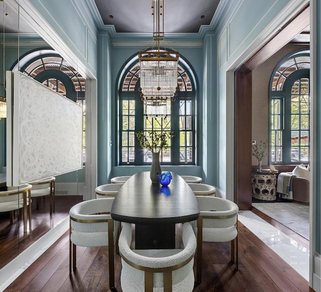 dining space with ornamental molding and a notable chandelier