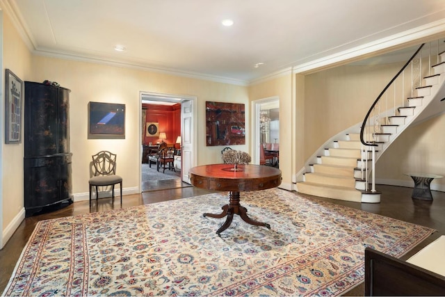 foyer with dark wood-type flooring and ornamental molding