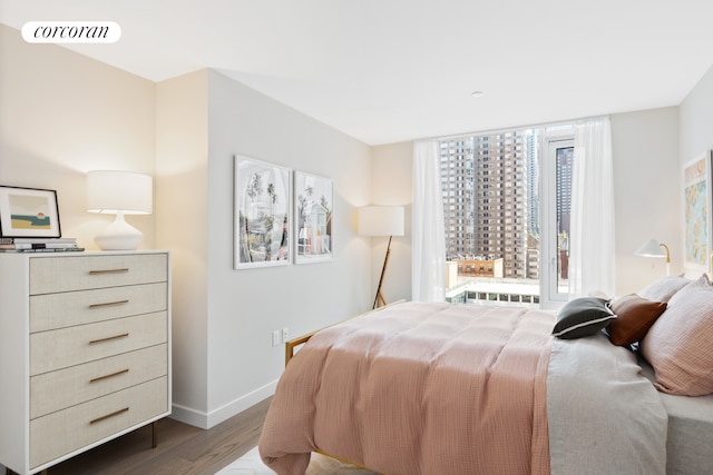 bedroom with baseboards, visible vents, and dark wood-type flooring