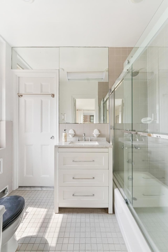 1 E End Ave Unit 3C, New York City, NY 10075 - full bathroom featuring vanity, tile patterned floors, enclosed tub / shower combo, and toilet
