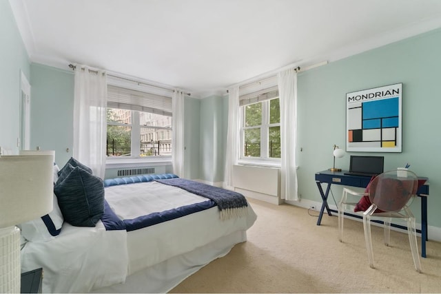 bedroom with radiator heating unit, light carpet, and crown molding