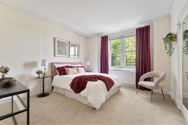 carpeted bedroom with ornamental molding