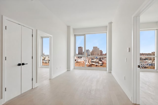 139 Bowery Unit 12B, New York City, NY 10002 - hall featuring light wood-type flooring and a skyline view
