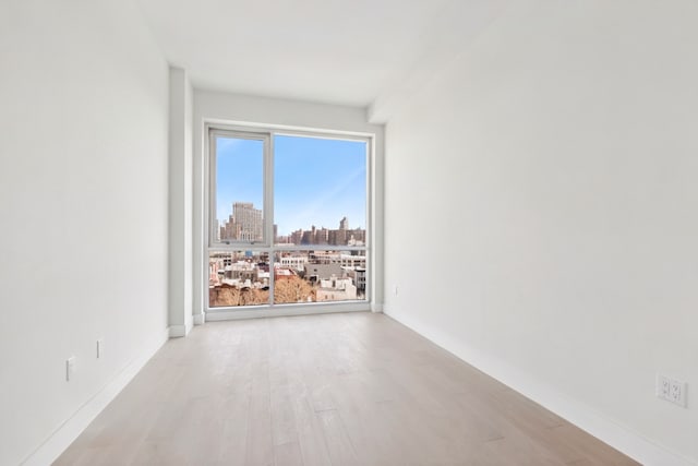 139 Bowery Unit 12B, New York City, NY 10002 - unfurnished room with wood finished floors and a city view