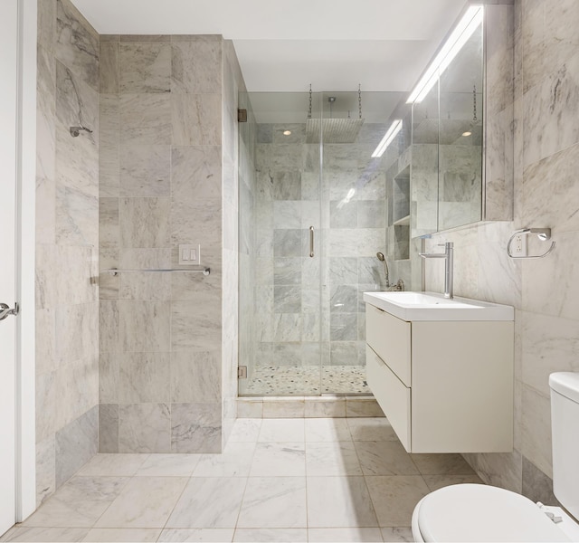 315 7th Ave Unit 3D, New York City, NY 10001 - bathroom featuring toilet, tile walls, a shower stall, and vanity