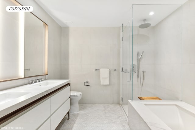 bathroom featuring toilet, tile walls, tile patterned floors, walk in shower, and vanity