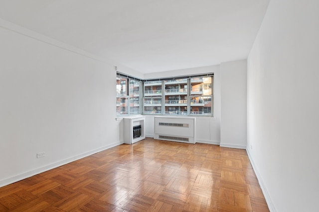 233 E 70th St Unit 10T, New York City, NY 10021 - unfurnished living room with radiator, heating unit, and a bar