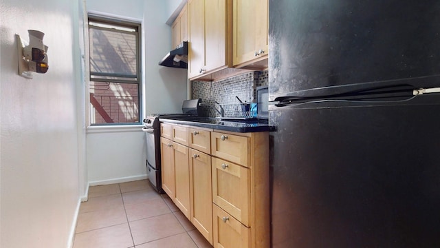 2191 Bolton St Unit 5E, New York City, NY 10462 - kitchen featuring under cabinet range hood, stainless steel range with gas cooktop, light brown cabinets, and freestanding refrigerator