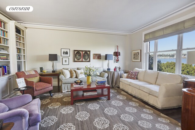 living room with a water view, visible vents, crown molding, and wood finished floors